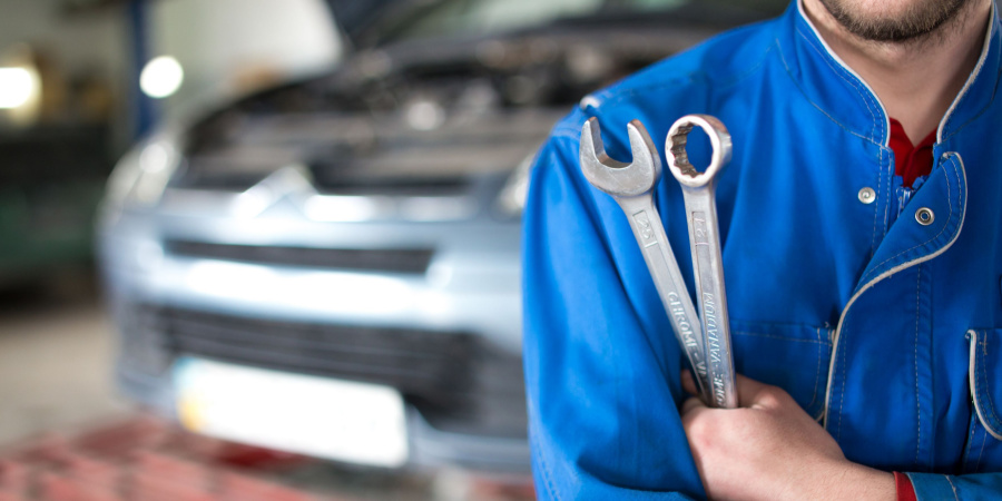 close-up photo of a vehicle technician holding a wrench | does the global skill gap threaten skilled labor