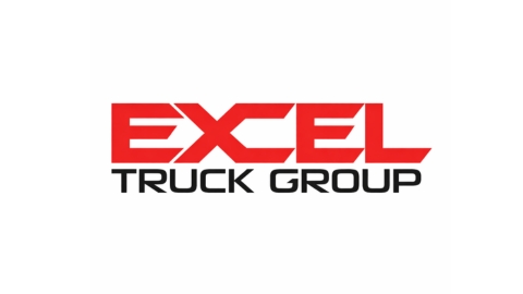 Excel Truck Group leadership and technicians collaborating in a commercial truck dealership, illustrating alignment, training, and operational excellence across a multi-location dealer network.